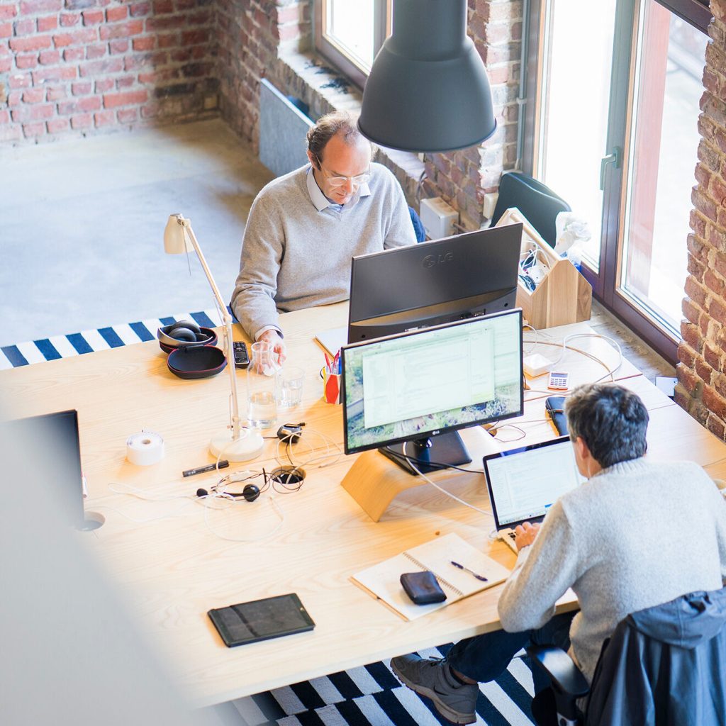 two men working on computers